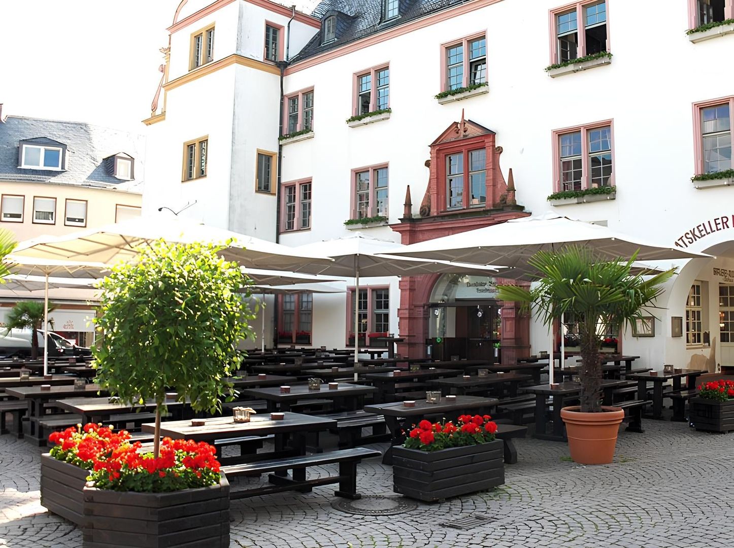 Beer garden with tables and chairs on the market square in front of the restaurant